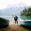 sophisticated picturesque wedding - bride and groom with canoes
