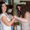 A Boho-Chic Wedding in Montego Bay - Bridesmaid Putting Bracelet on Bride