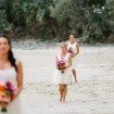 A Colourful DIY Beach Wedding in Australia - Bridesmaids Walking Down Beach During Ceremony