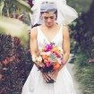 A Colourful DIY Beach Wedding in Australia - Close-up of Bride Looking Down at Bouquet