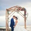 A Colourful DIY Beach Wedding in Australia - Bride and Groom Under Arbour