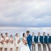 A Colourful DIY Beach Wedding in Australia - Couple Facing Each Other with Bridal Party Watching