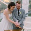 timeless, elegant white wedding in manitoba - bride and groom cutting cake