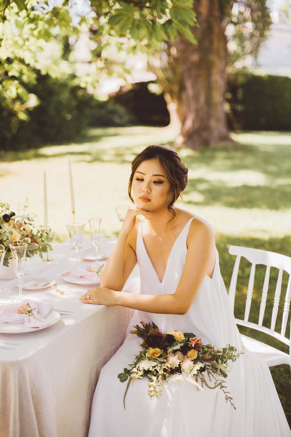 Modern Autumn Botanical Wedding Inspo - Bride sitting at table