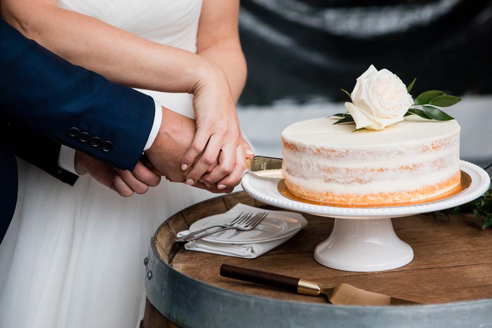 A-Modern-Lakeside-Wedding-In-Burnaby-British-Columbia-Cutting the Cake
