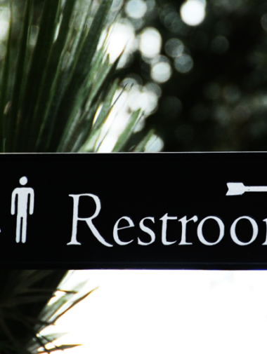 Restroom arrow sign