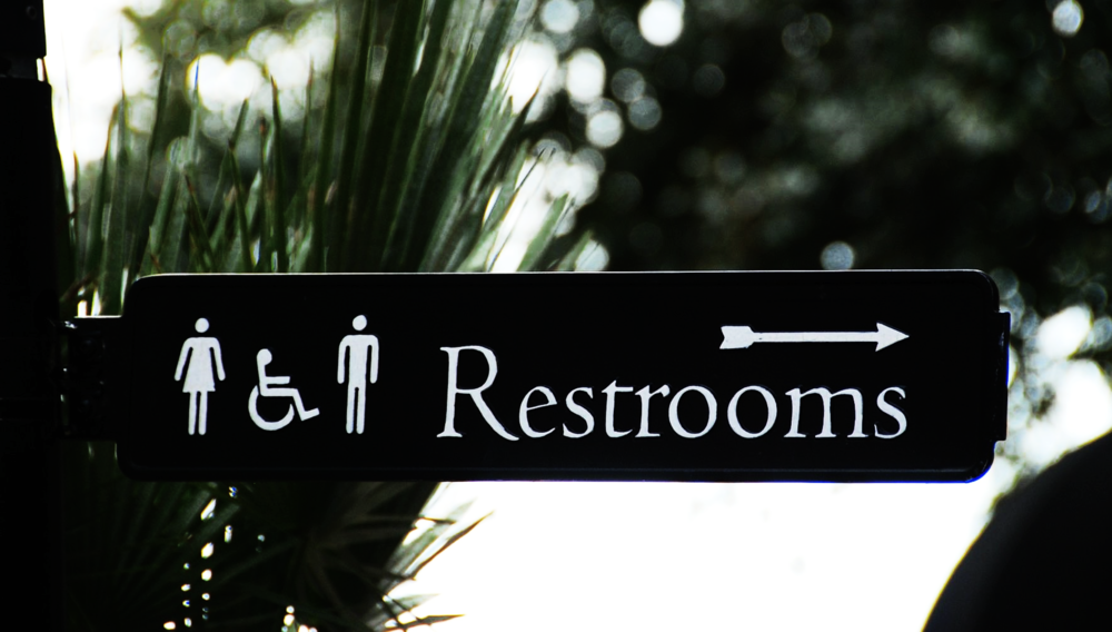 Restroom arrow sign